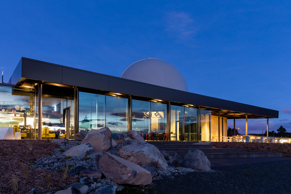 Exterior of Dark Sky Project Base Building from Lake in evening
